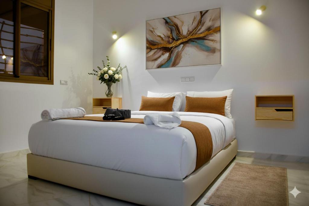 a bedroom with a large bed in a room at Hotel America Apartments in Dakhla