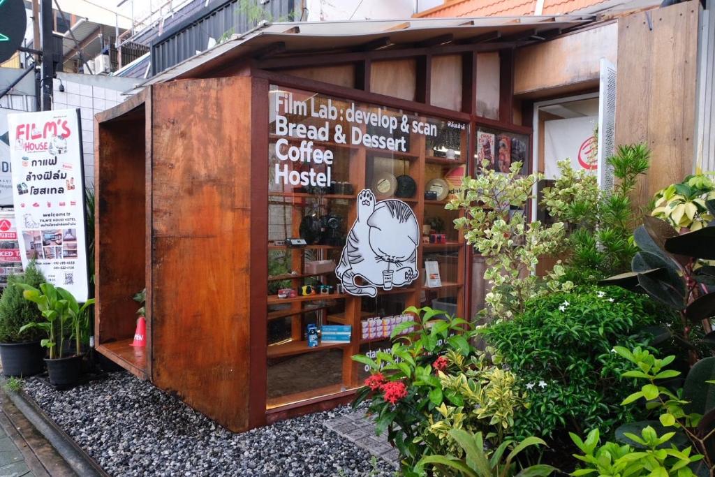 a coffee shop with a sign on the front of it at Films House Hostel in Bangsaen