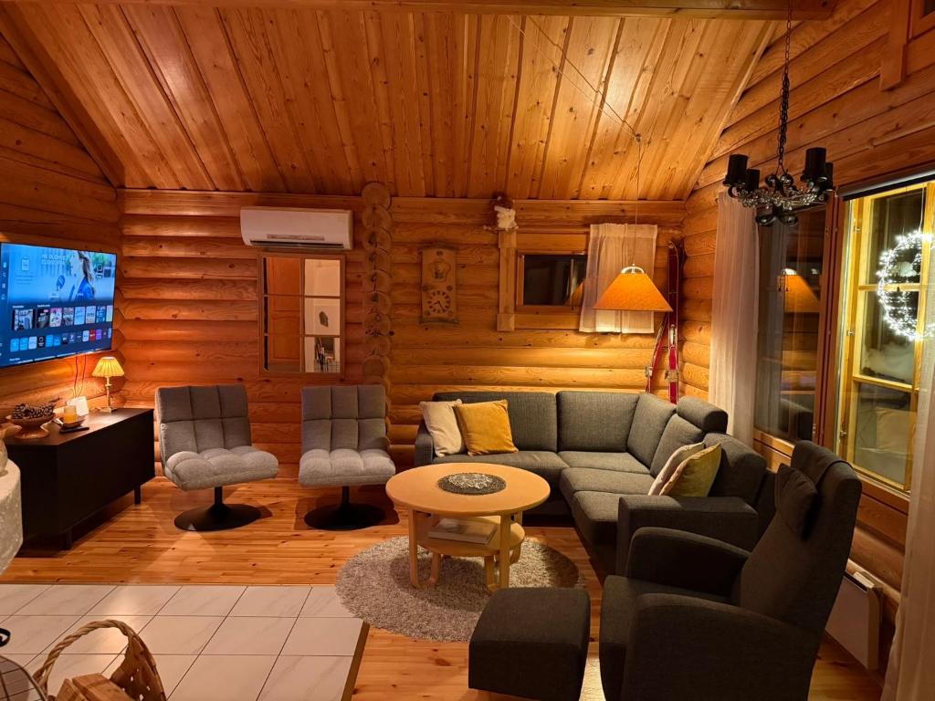 ein Wohnzimmer mit Sofa und Tisch in der Unterkunft Villa Rukan Honka in Ruka