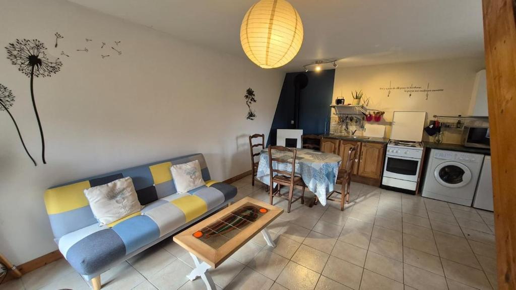 a living room with a couch and a table at Les gîtes de la salamandre in Callac
