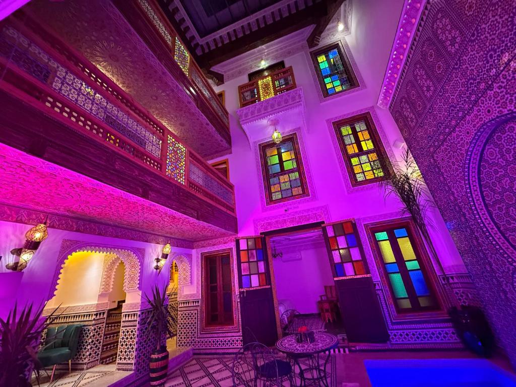 a room with purple lights on the ceilings at Riad Dar El bellar in Fès