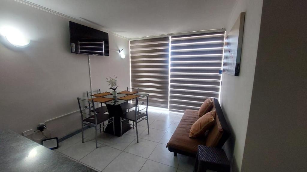 a living room with a table and a couch at Matiz Cavancha II in Iquique