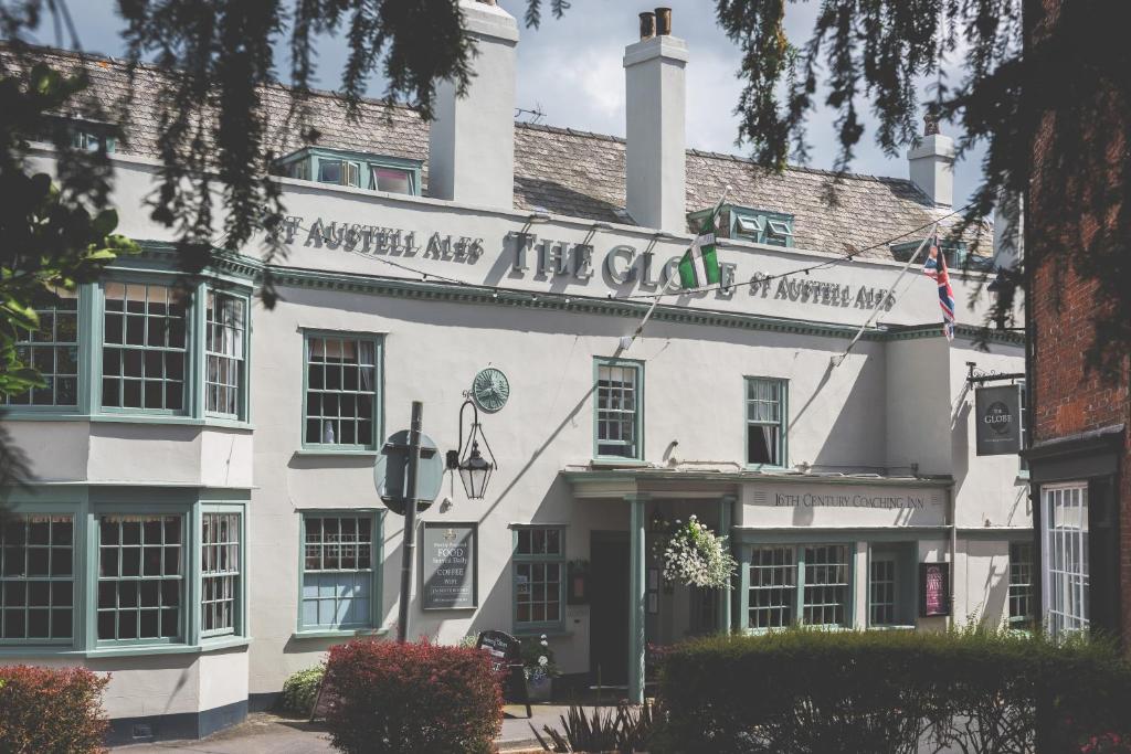 a white building with a sign that reads the claus at The Globe in Exeter