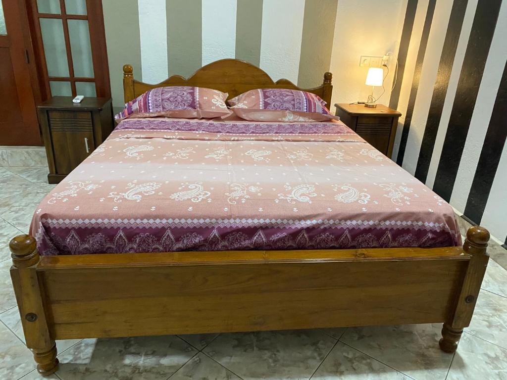 Ένα ή περισσότερα κρεβάτια σε δωμάτιο στο Dona's Villa, Coastal Tropical House