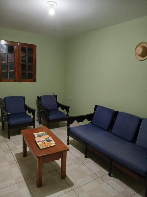 - un salon avec des canapés bleus et une table basse dans l'établissement Casa ou Quartos, à Surubim