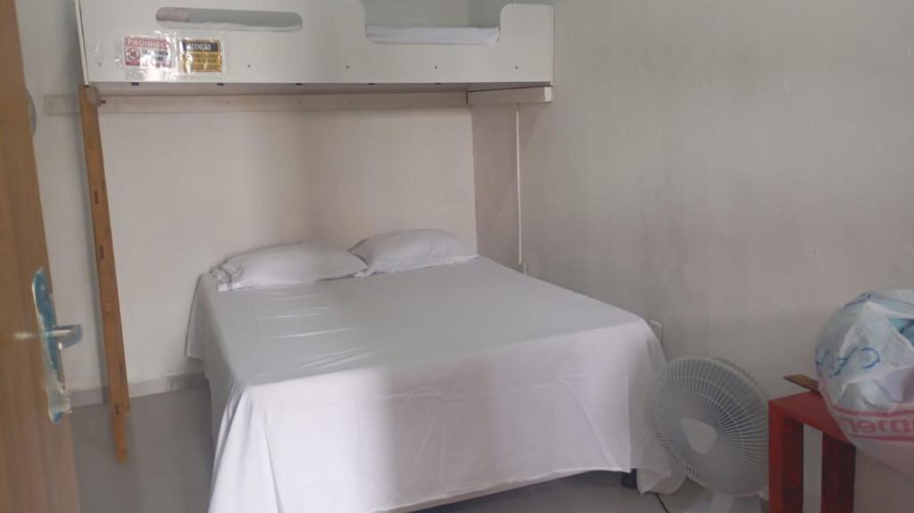 En eller flere senge i et værelse på Suíte quase frente à rodoviária