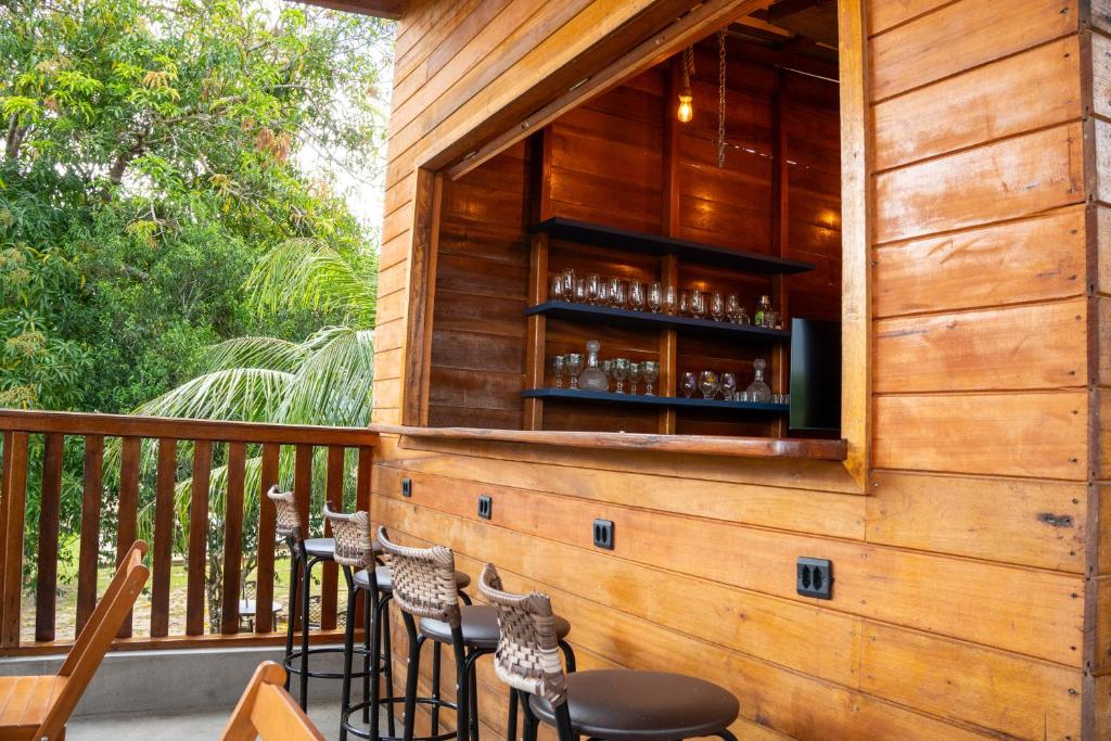 a bar on the deck of a house at Ybyra Pousada de Selva in Careiro