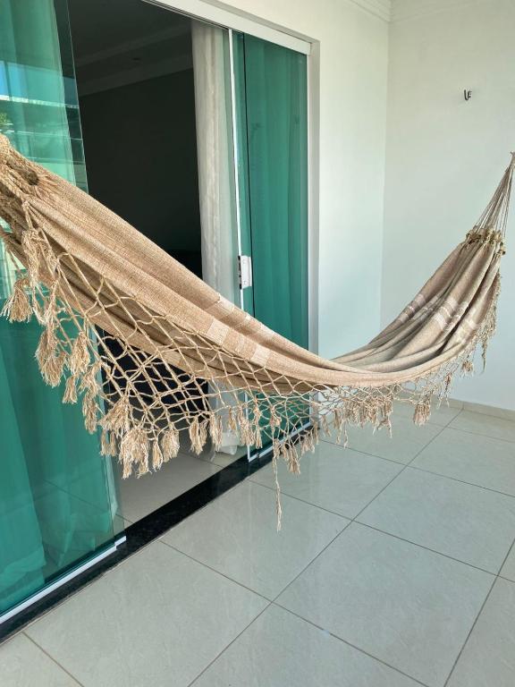 a hammock is hanging outside of a building at Casa - Candeias- Jaboatão dos Guararapes in Recife