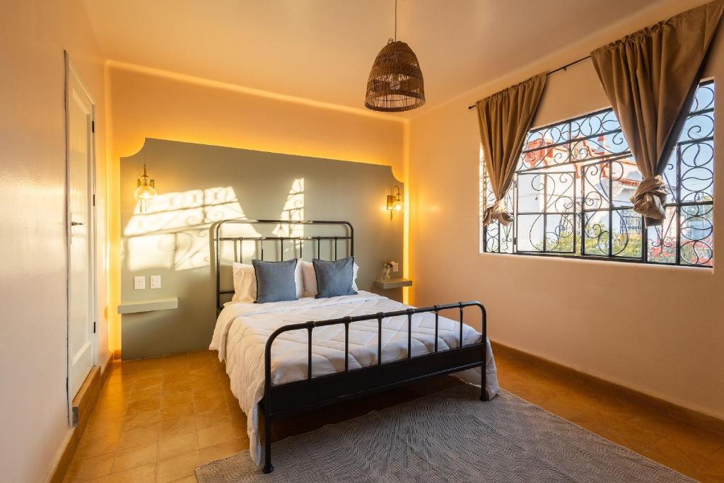 a bedroom with a bed and a window at Casa 906 in Puebla