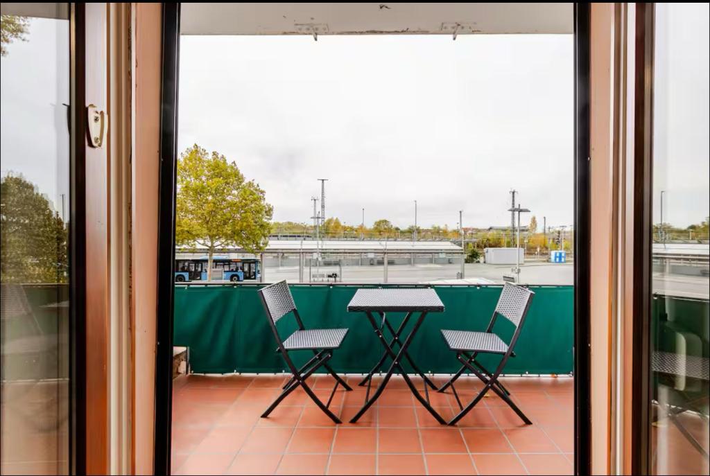 a table and two chairs on a balcony at Worms City Apartment in Worms