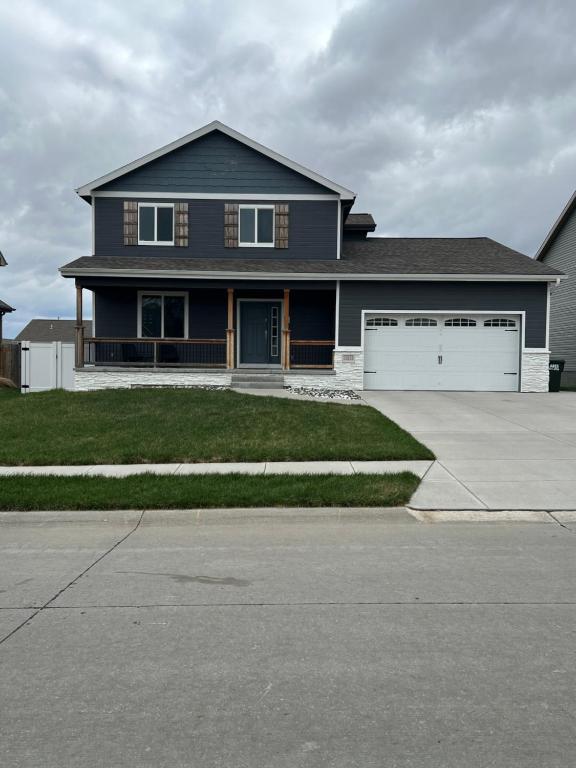 a large blue house with a white garage at Blue Diamond Dream in Bennington
