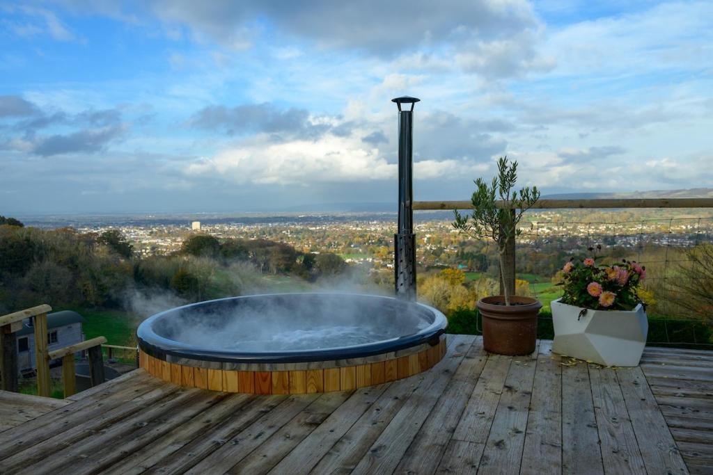 a large hot tub on a wooden deck with a view at Sky Garden Cabin - Cabin in the Clouds in Charlton Kings