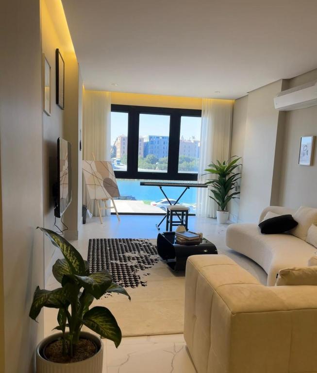 a living room with a couch and a table at Chicago Apartment in Al Khobar