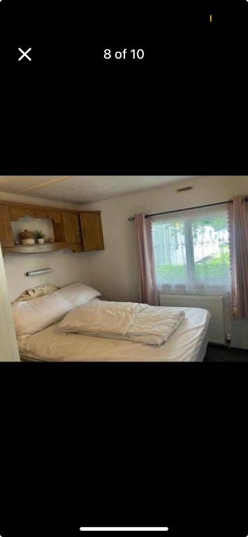 a bedroom with a bed and a window at CSS butlins Skegness retreat in Skegness