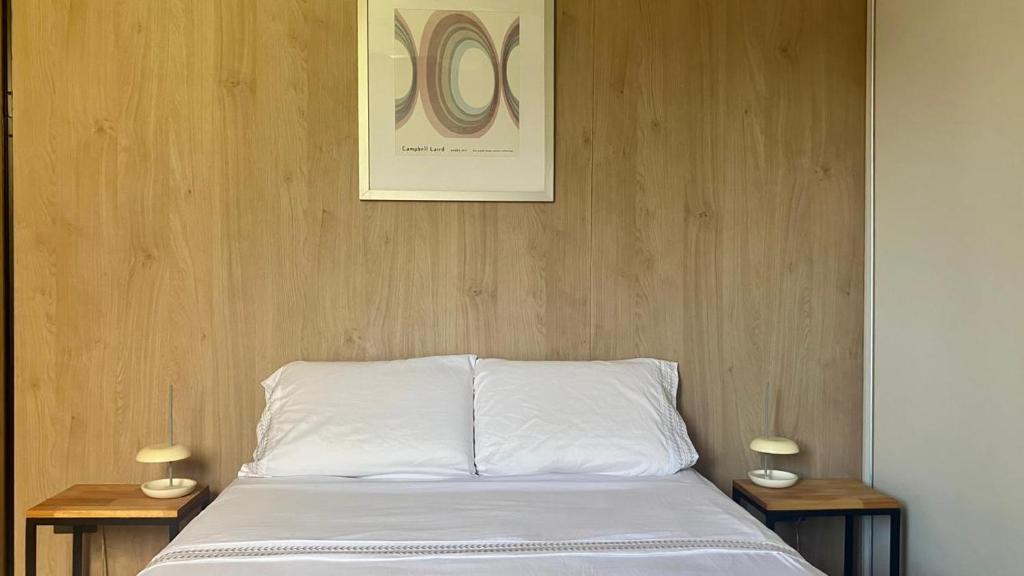 a bedroom with a bed with two side tables at Casa Vino Andino in La Consulta