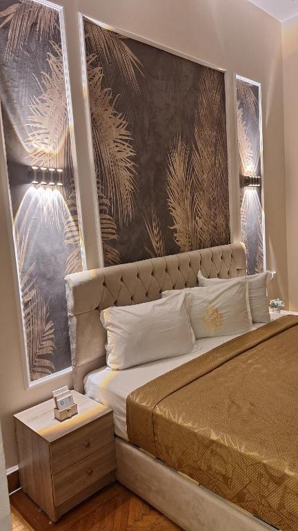 a bedroom with a bed with a large wall mural at Downtown House Suites in Cairo