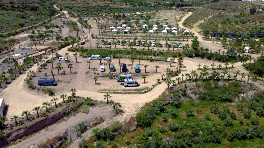 an aerial view of a parking lot with palm trees at Parcela autocaravana o tienda propia - Wellnesscamp Oasis Al Hamam in Lucainena de las Torres