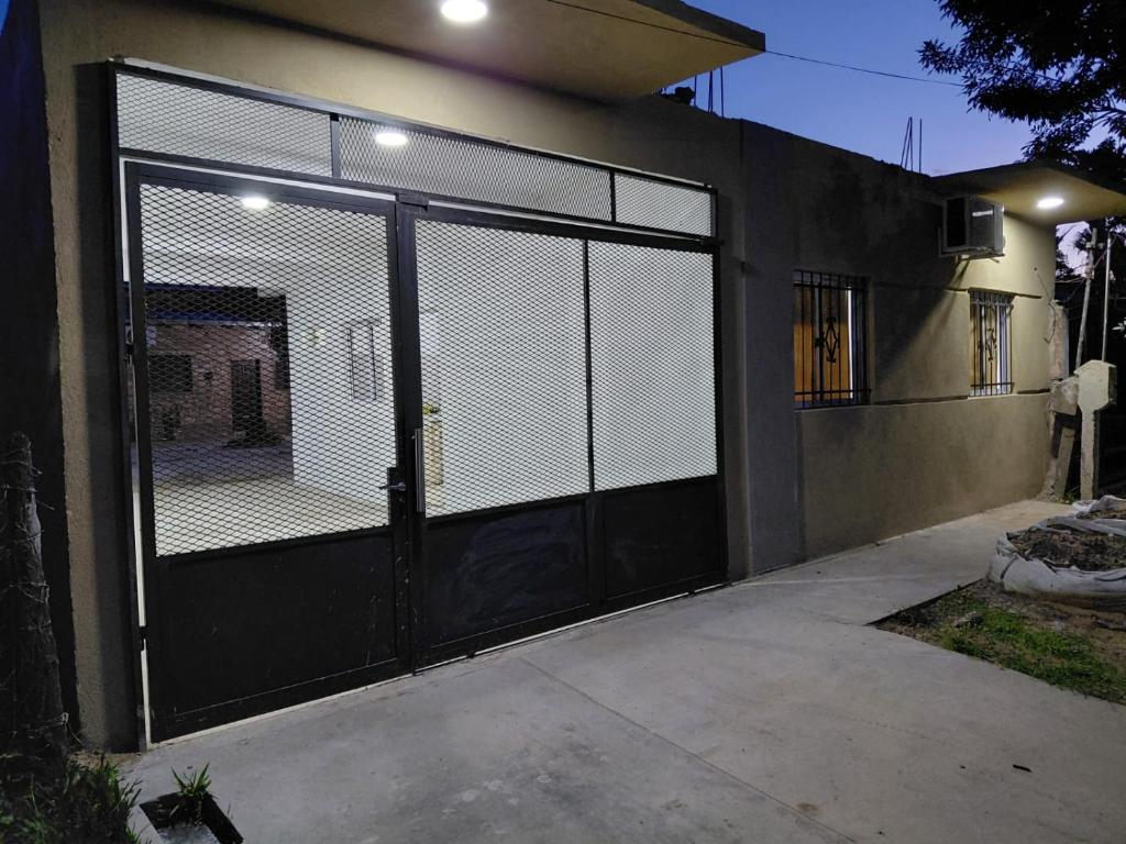 a garage door with a gate on the side of a house at Alojamiento Marcenal in Empedrado