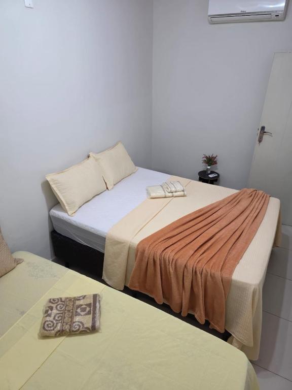 two beds sitting next to each other in a room at Eds pousada in Juazeiro do Norte