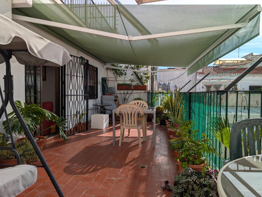 a patio with a table and chairs on a balcony at Apartment near Fira Barcelona, Camp Nou, and the center of Barcelona in Hospitalet de Llobregat