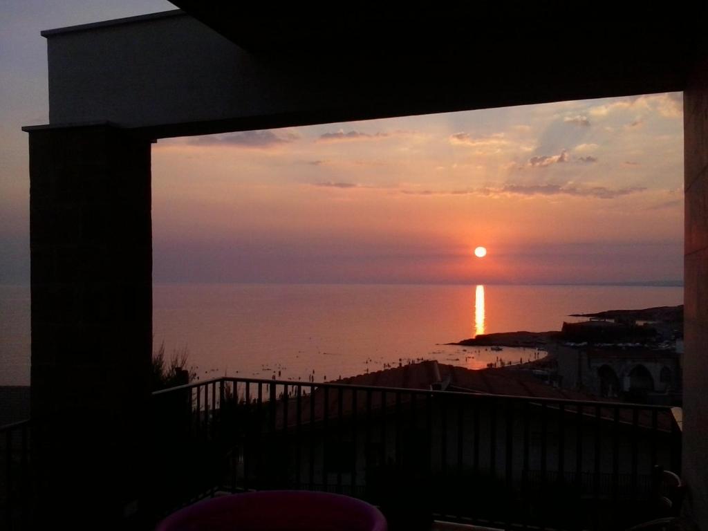 a sunset from the balcony of a house at Vision of the Sea in Cava D'aliga