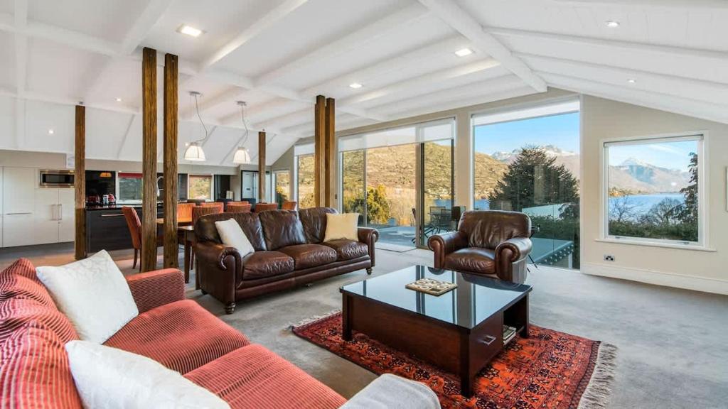a living room with couches and a table at Stewart Lodge Luxury Spa in Queenstown