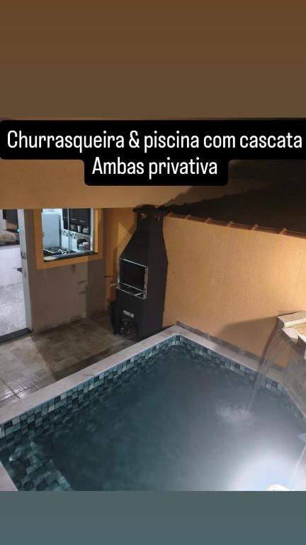 a view of a swimming pool in a house at Casa de condomínio com piscina e churrasqueira in Sao Paulo