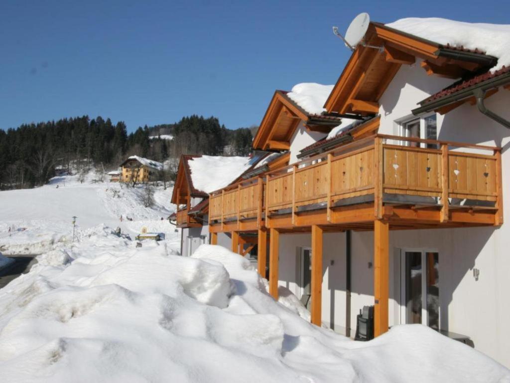 un bâtiment recouvert de neige, entouré de neige dans l'établissement Kipaji 2, à Kötschach-Mauthen