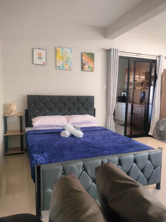 a bedroom with a bed with a blue comforter at Stay at Diez in Calamba