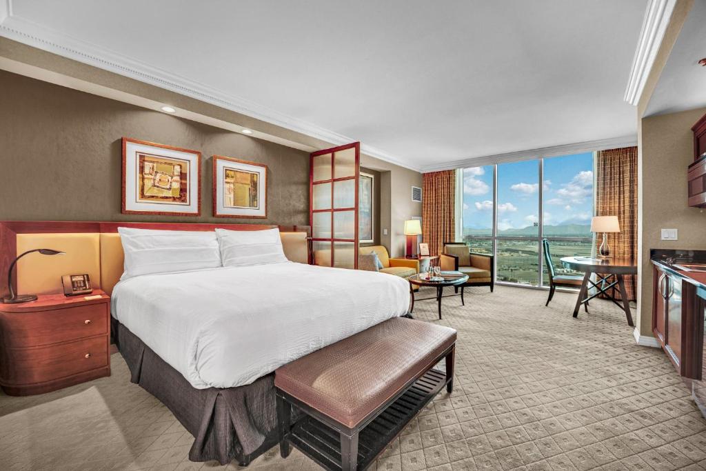 a bedroom with a large bed and a living room at Solara Vita at MGM Signature in Las Vegas