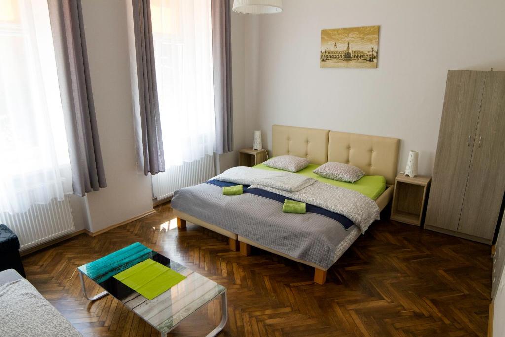 a bedroom with a bed and a table in it at Dream Hostel & Apartments in Kraków