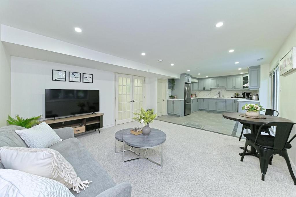 a living room with a couch and a table at SPACIOUS FULLY PRIVATE 2BR UNIT ON GROUND Private 2BR LEVEL in Burlington