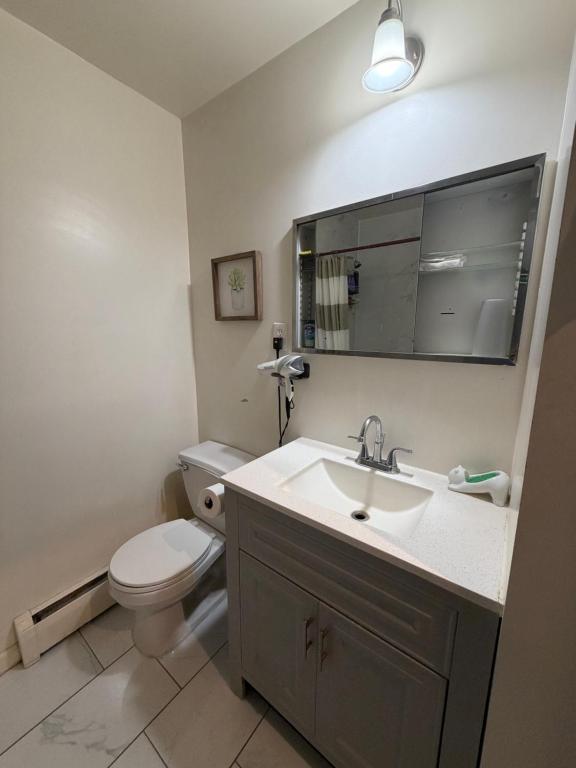 a bathroom with a sink and a toilet at A sweet home-Room D in Woodside