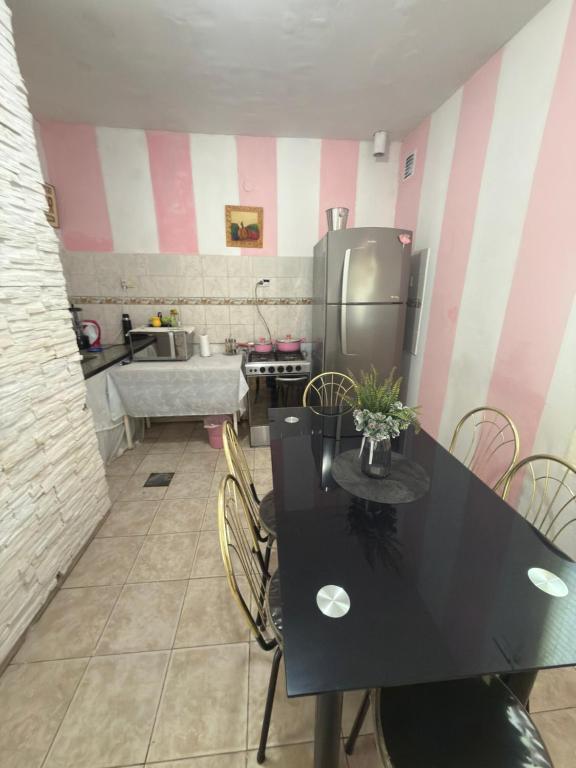 a kitchen with a black table and a refrigerator at YBVerde in Yerba Buena