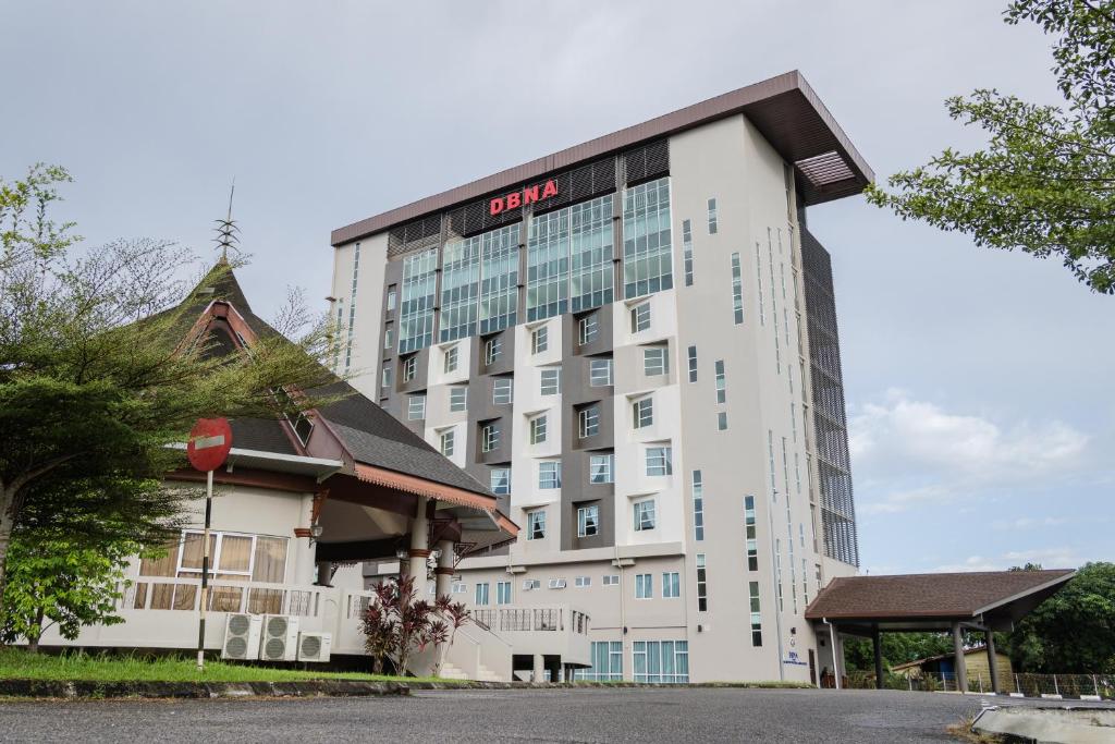 a large white building with a sign on it at DB Stay in Kuching