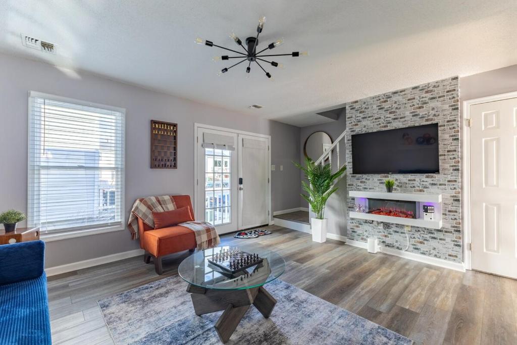 a living room with a fireplace and a tv at BoardGame Bungalow in Atlantic City