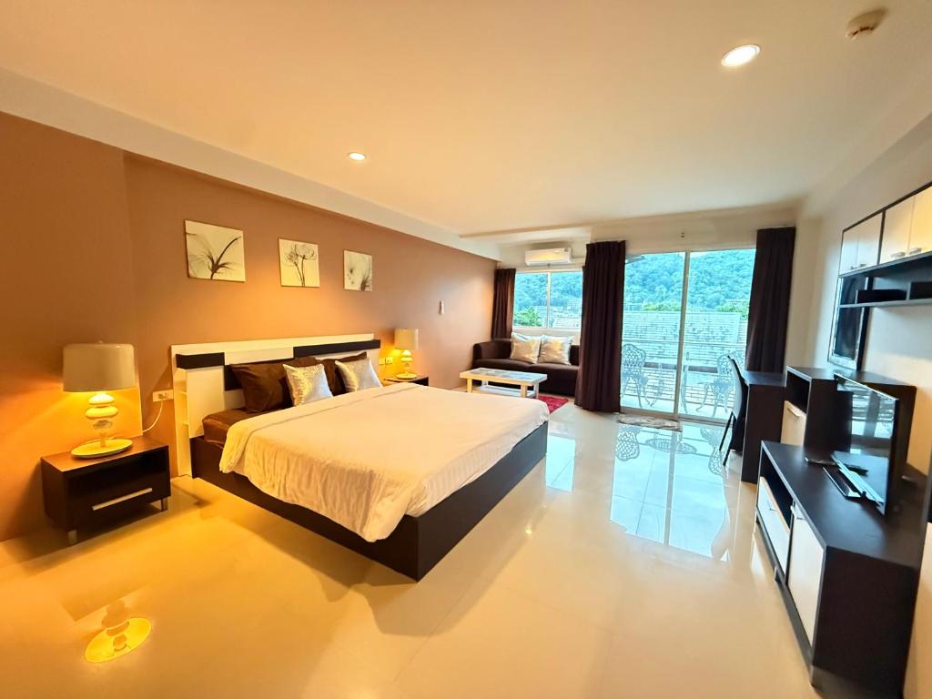 a large bedroom with a bed and a television at Aonang Mountain View A5 in Ao Nang Beach
