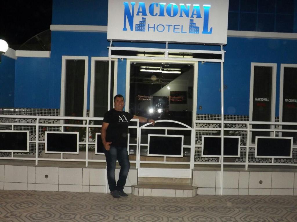 a man is standing in front of a hotel at Nacional Hotel in Itacarambi