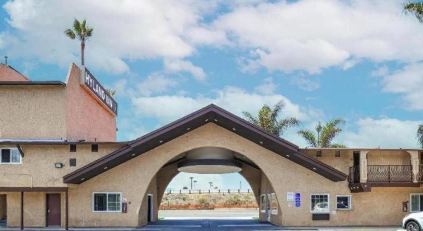 a building with an archway in a parking lot at Rodeway Inn Carlsbad in Carlsbad