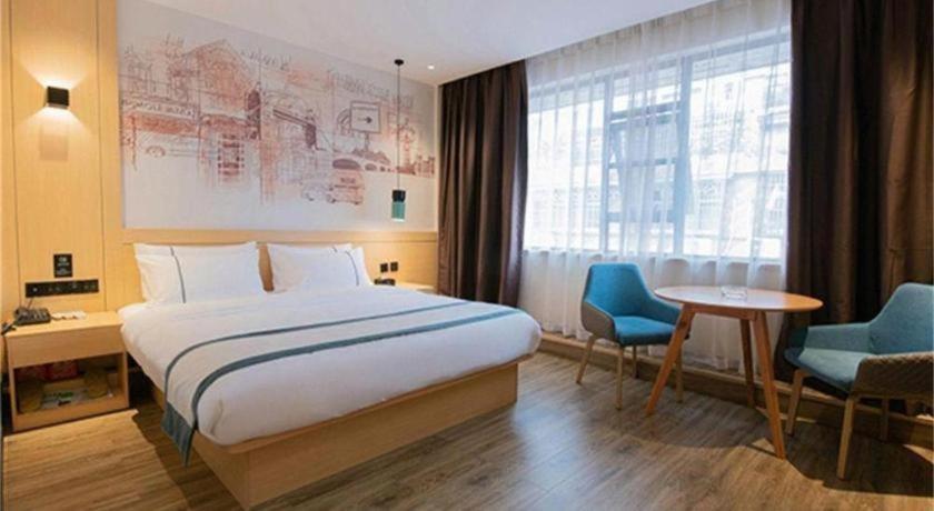 Postel nebo postele na pokoji v ubytování City Comfort Inn Dali High-speed Railway Station Erhai Park