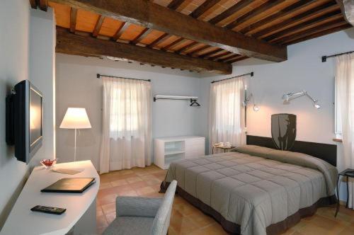 A bed or beds in a room at Locanda Della Picca