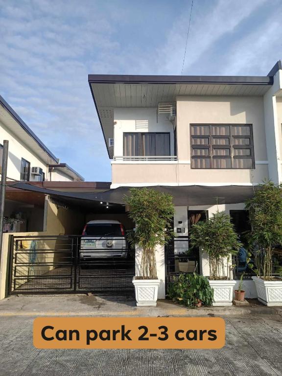 a house with a car parked in front of it at Bali Residences in Agus