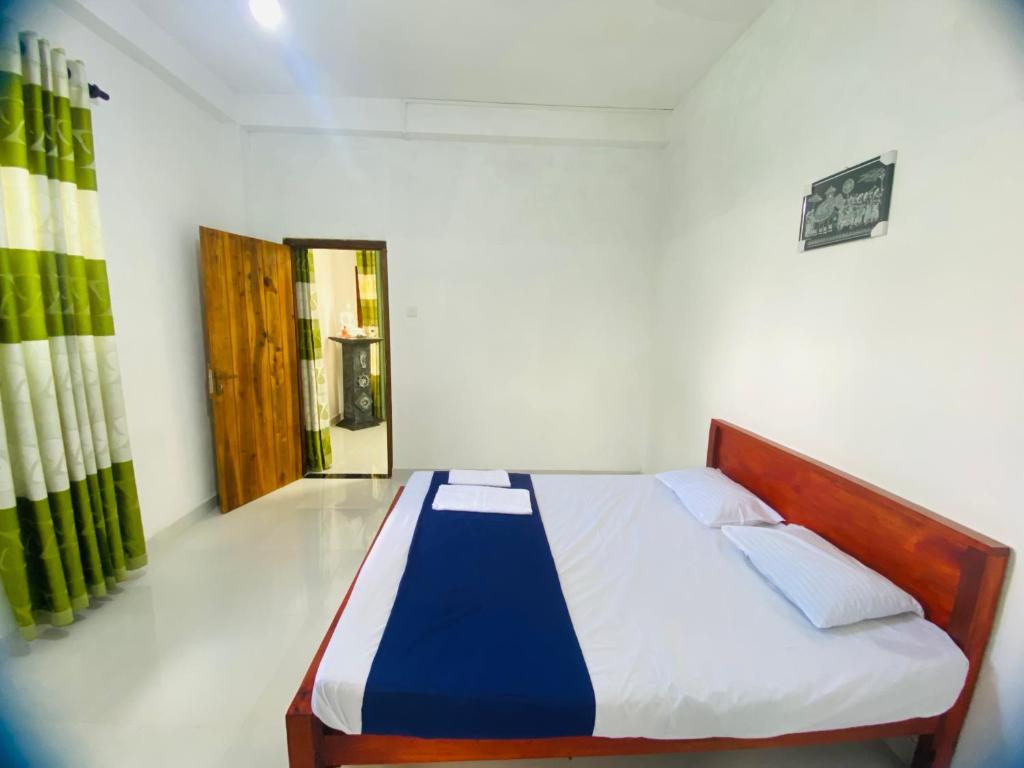 Postel nebo postele na pokoji v ubytování Sri Elegance Stay