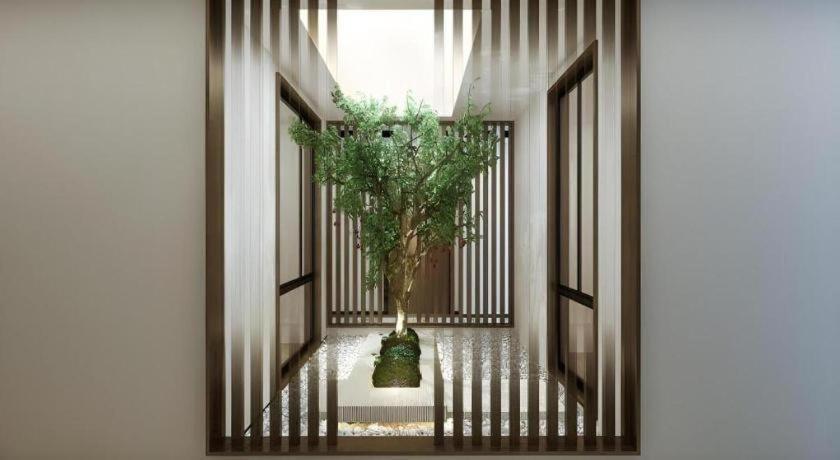 a hallway with a plant in a vase at GreenTree Inn Express Hainan Haikou Haixiu Zhong Road in Haikou