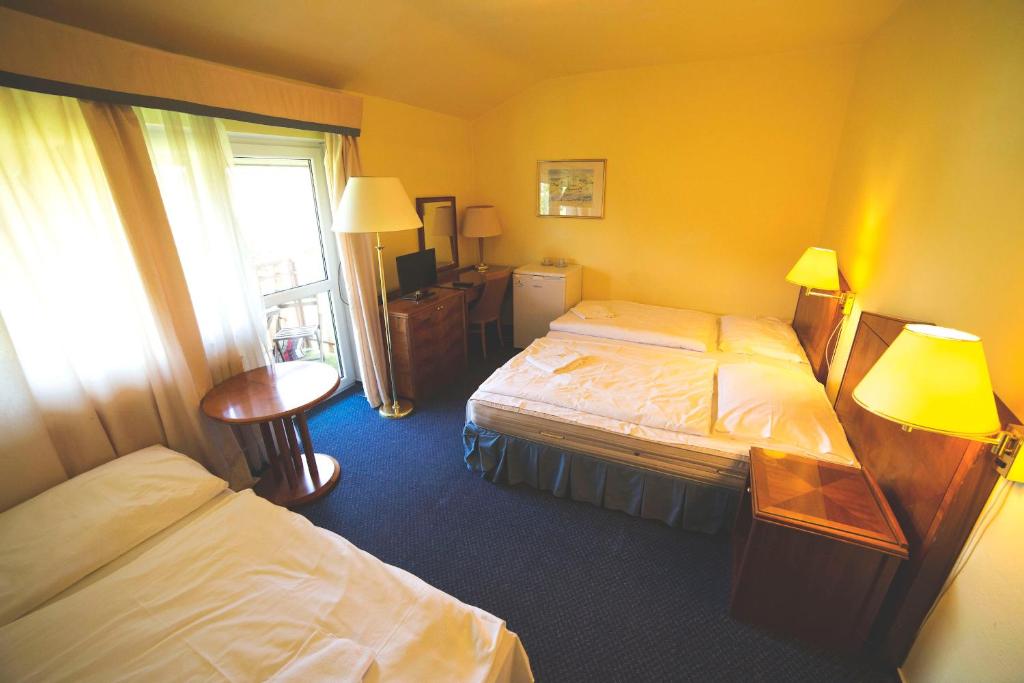 Letto o letti in una camera di Hotel Racek