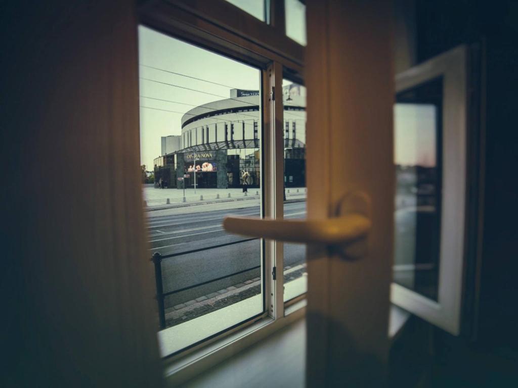 a door with a window with a view of a building at Apartament Focha 26 in Bydgoszcz