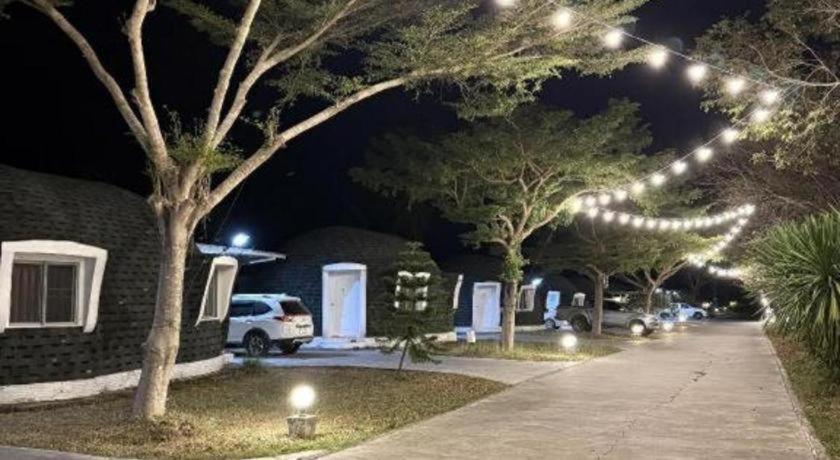 a row of trees lit up at night with lights at Eskimo Resort in Ban Pa Kruat