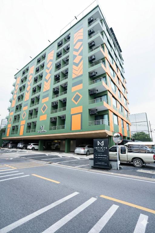 a large building with an advertisement on the side of it at Infinite Hotel-Ratchada in Bangkok