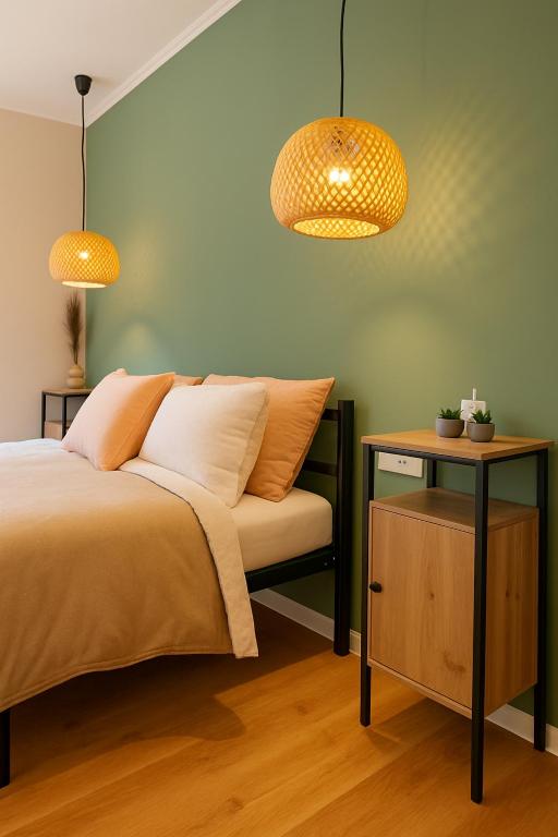 a bedroom with a bed with two lamps and a table at ZiAna - Hiperbara Livezeni in Livezeni