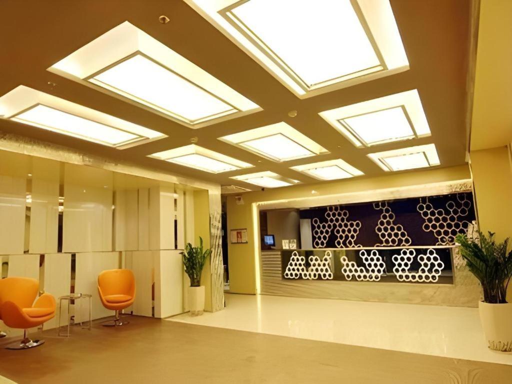 an office lobby with orange chairs and skylights at Jinjiang Inn Taiyuan Longtan Park in Taiyuan